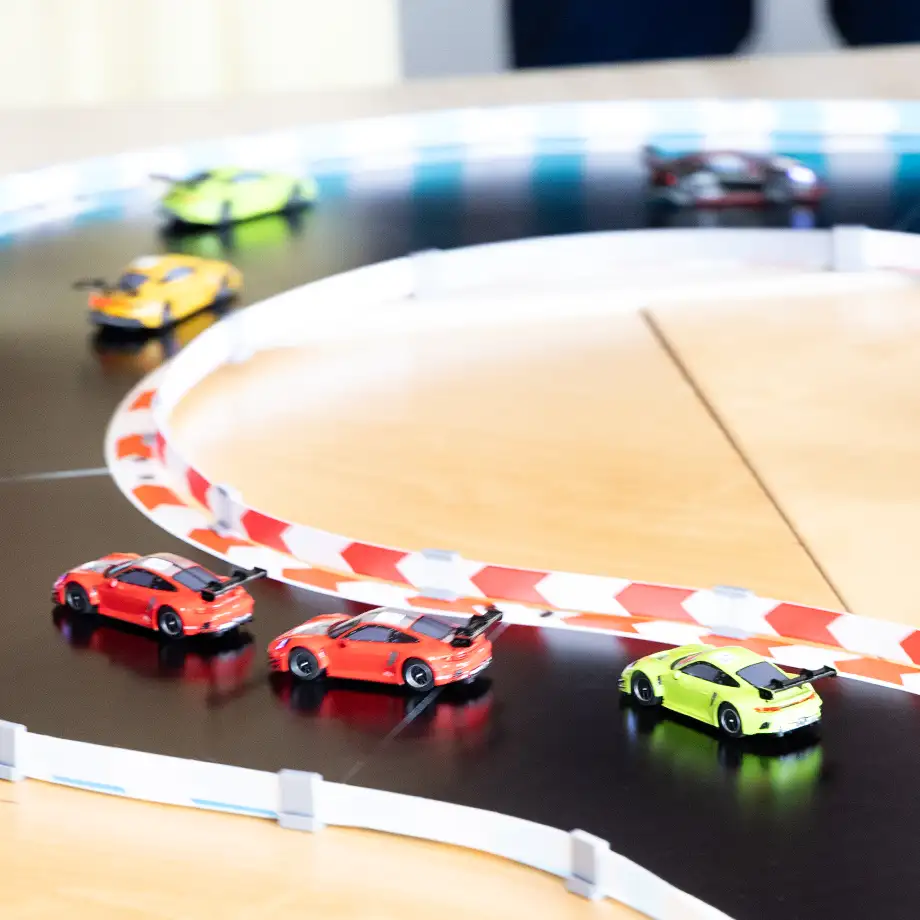 Various Carrera cars race around a Carrera racetrack